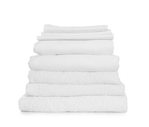 Stack of towels and bed sheets on white background