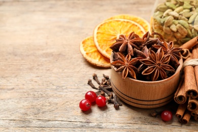 Photo of Composition with mulled wine ingredients on wooden table. Space for text