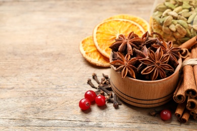 Composition with mulled wine ingredients on wooden table. Space for text