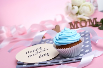 Festive surprise with tasty treat for Mother's Day on color background