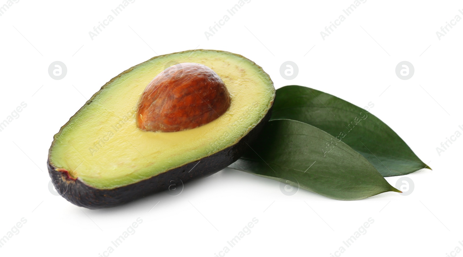 Photo of Half of ripe avocado with pit and green leaves on white background