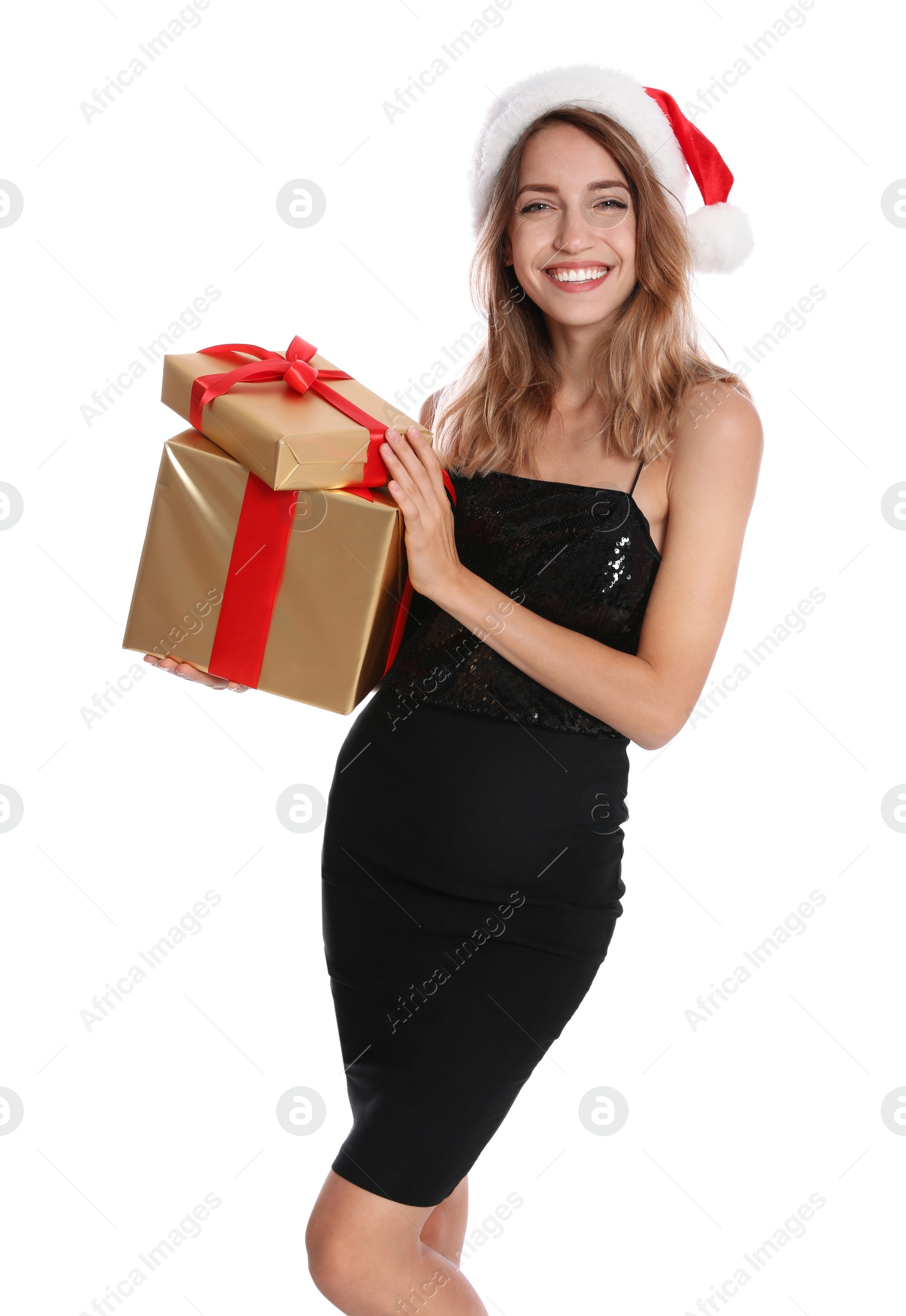 Photo of Happy young woman in Santa hat with gift boxes on white background. Christmas celebration