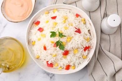 Photo of Bowl of delicious rice with vegetables and parsley on table, flat lay