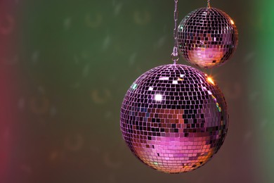 Photo of Shiny disco balls on color background, space for text