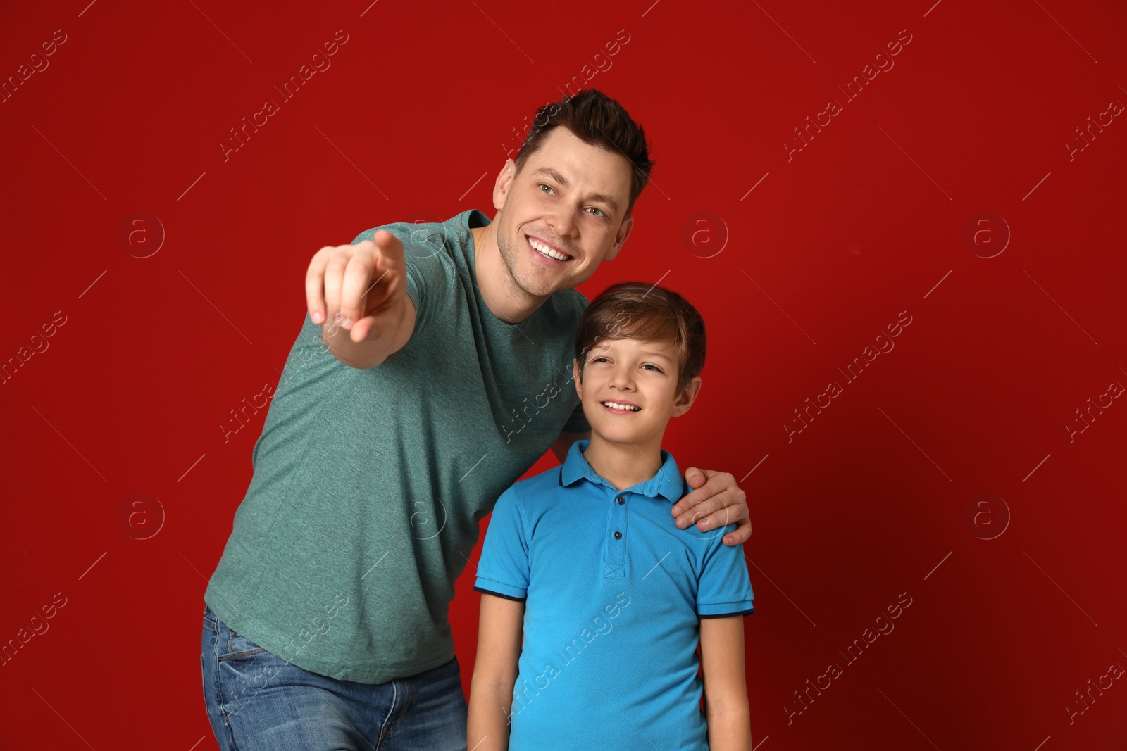 Photo of Portrait of dad and his son on color background