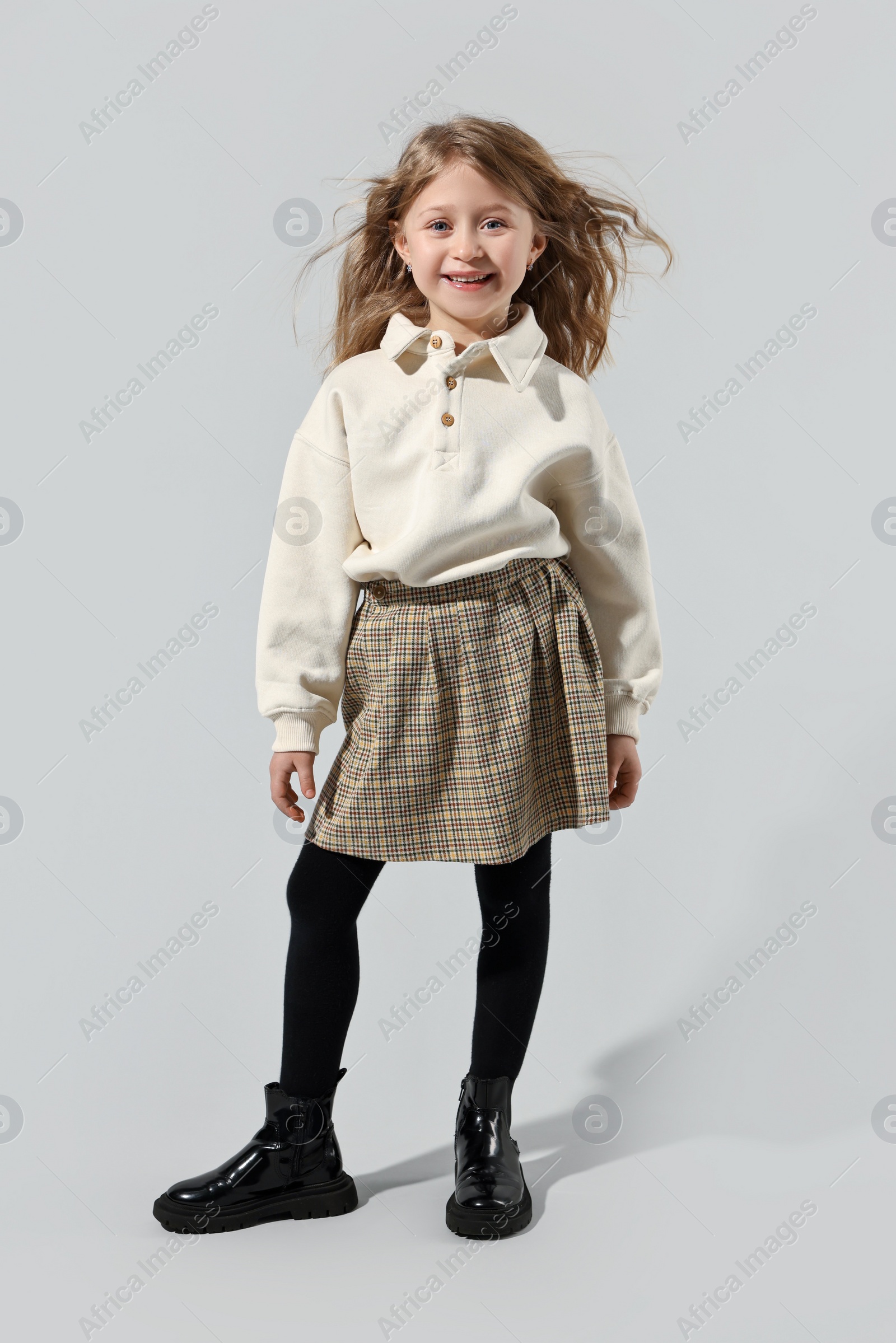 Photo of Fashion concept. Stylish girl posing on light grey background