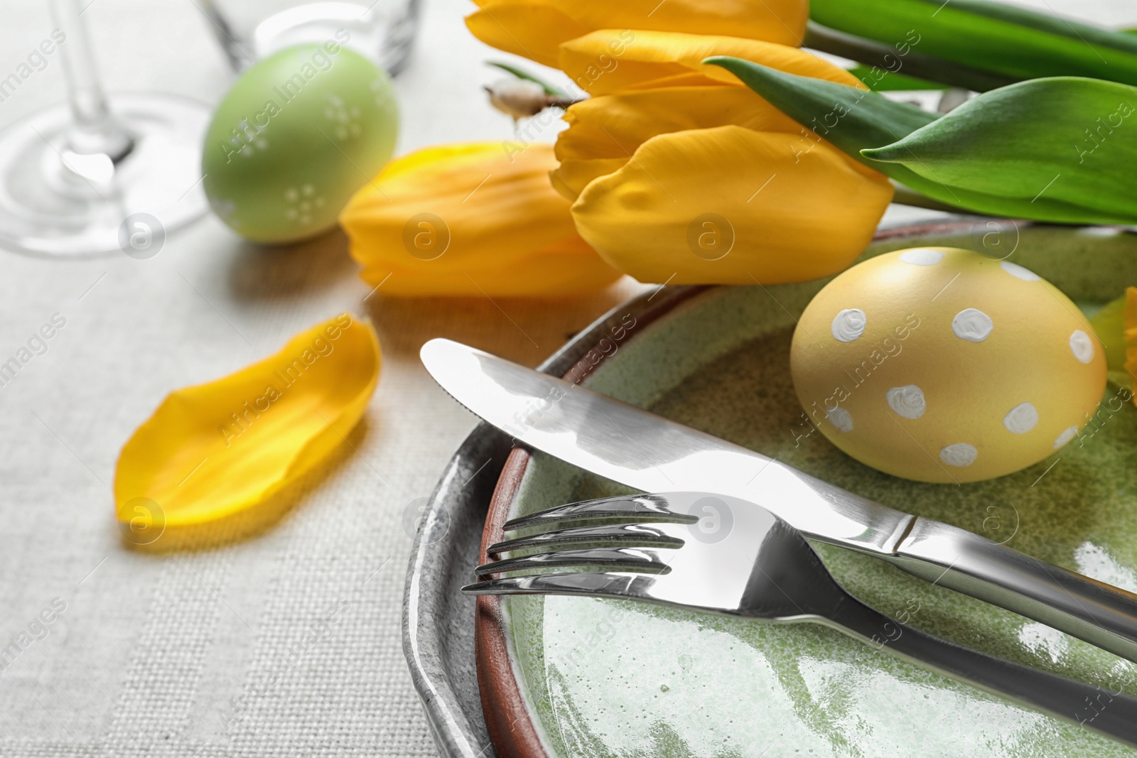 Photo of Festive Easter table setting with painted eggs, closeup. Space for text