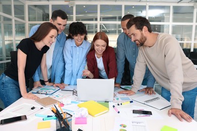 Team of employees working together at table in office. Startup project