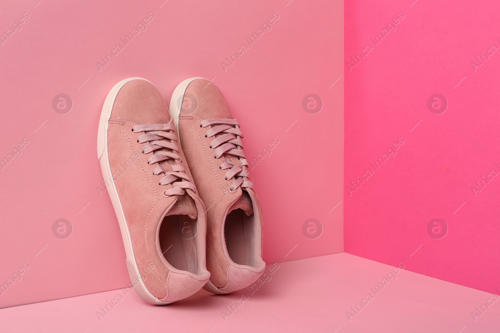 Photo of Comfortable sneakers on color background, space for text