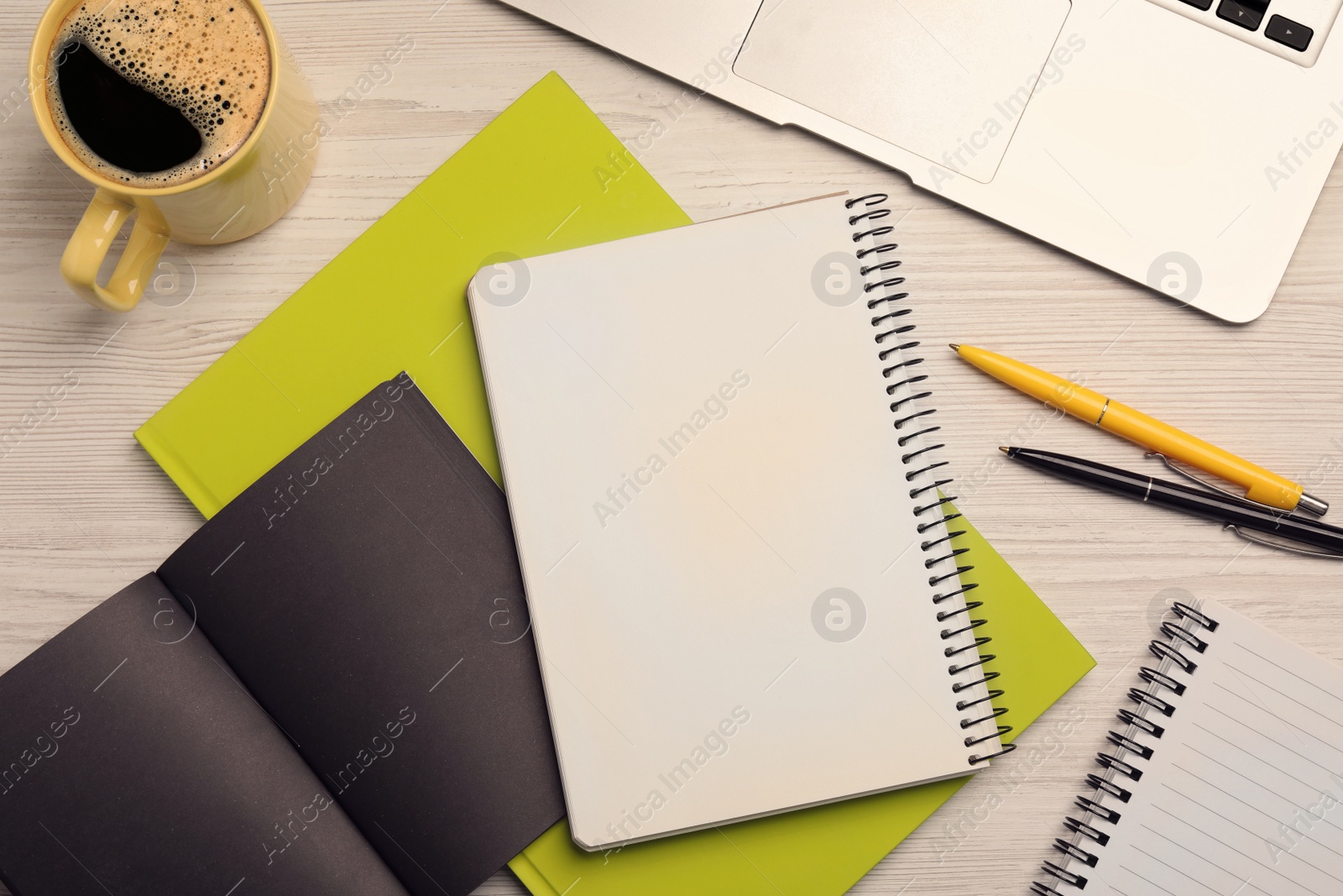 Photo of Flat lay composition with different notebooks, coffee and pens on wooden table