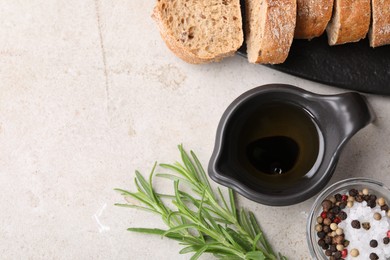 Photo of Saucepan of organic balsamic vinegar with oil, spices and bread slices on beige table, flat lay. Space for text