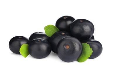 Photo of Pile of fresh ripe acai berries and green leaves on white background