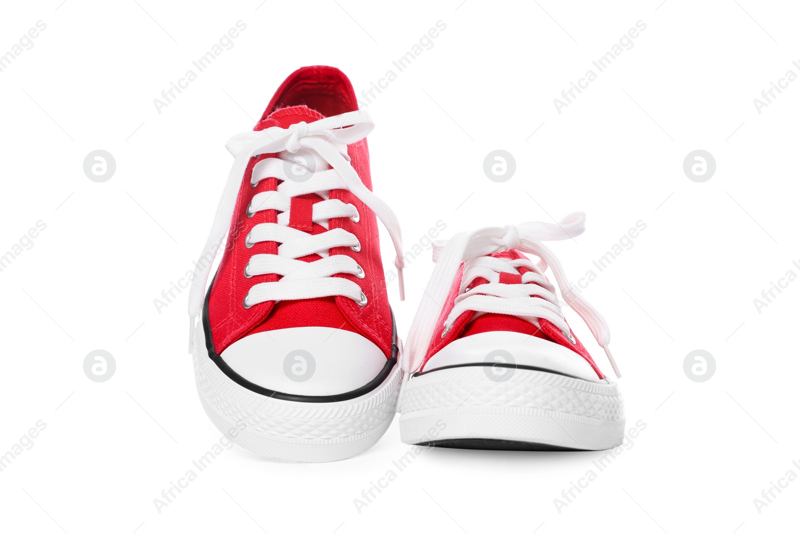 Photo of Pair of red classic old school sneakers on white background