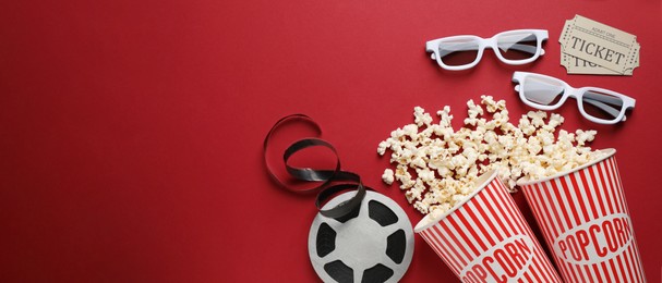 Flat lay composition with delicious popcorn and glasses on red background, space for text. Banner design