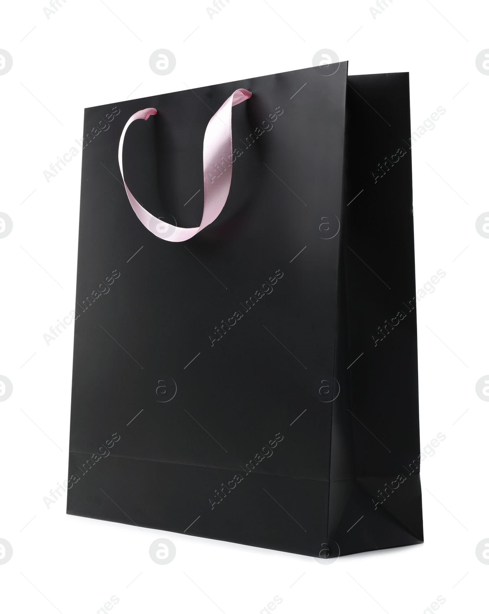 Photo of Paper shopping bag with ribbon handles on white background. Mockup for design