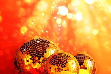 Image of Shiny disco balls under golden lights, bokeh effect