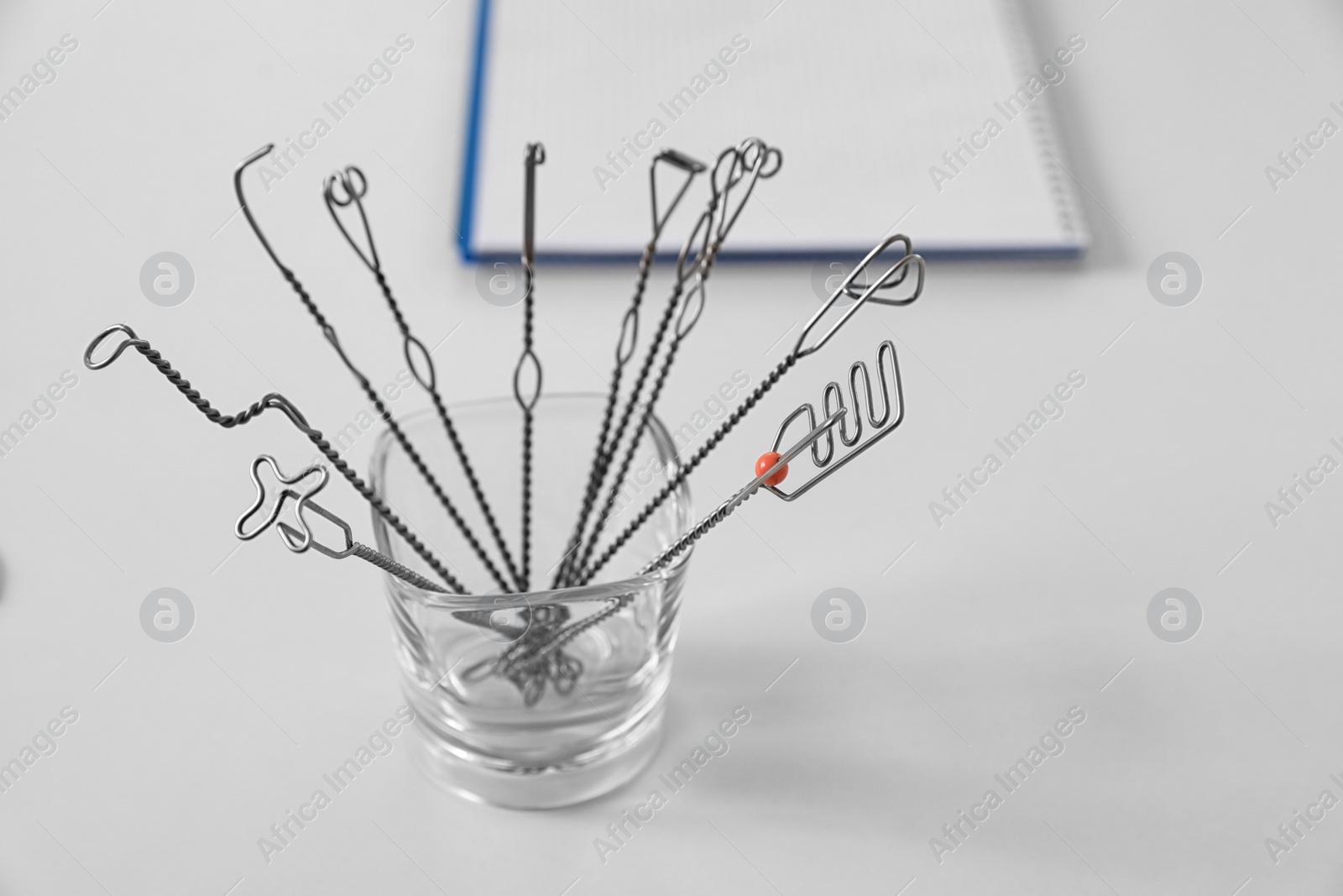 Photo of Set of different logopedic probes in holder on light table. Speech therapist's tools