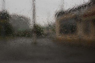 Photo of Rain drops on window glass, closeup. View from inside