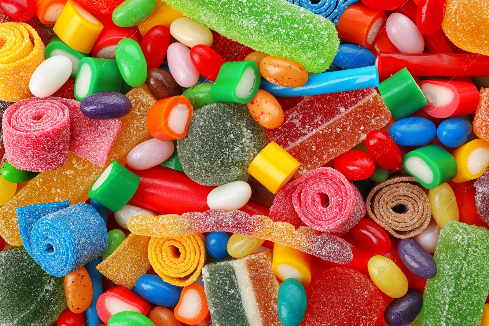 Photo of Pile of delicious colorful chewing candies as background