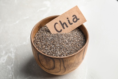 Photo of Bowl with chia seeds on grey background