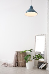 Photo of Modern room interior with large mirror and wicker basket