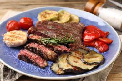 Photo of Delicious grilled beef with vegetables and rosemary on table, closeup