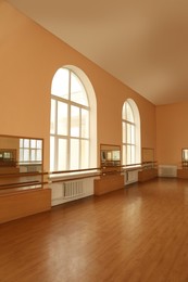 Photo of View of empty studio with mirrors and ballet barres