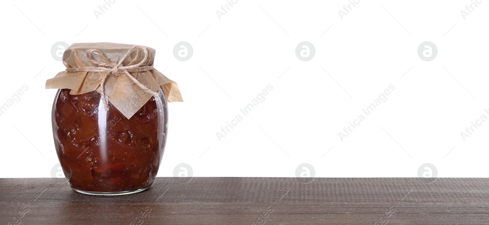 Photo of Jar with delicious apple jam on wooden table against white background