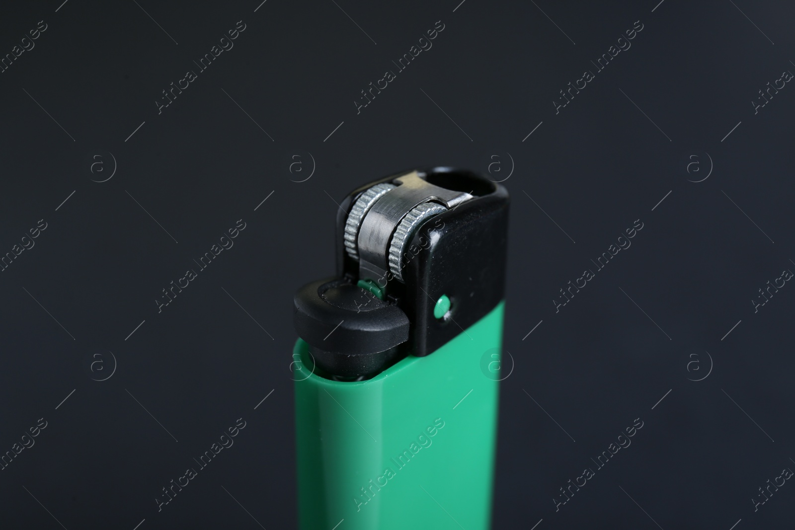 Photo of Stylish small pocket lighter on black background, closeup