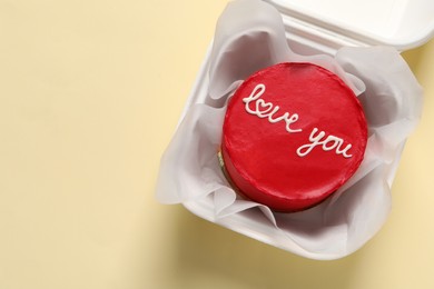 Photo of Bento cake with Love You text in takeaway box on beige table, top view. Space for text. St. Valentine's day surprise