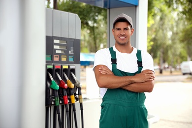 Worker in uniform at modern gas station