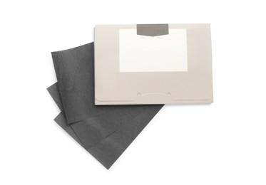 Package with facial oil blotting tissues on white background, top view. Mattifying wipes