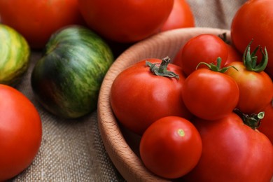 Photo of Many different ripe tomatoes on table, closeup