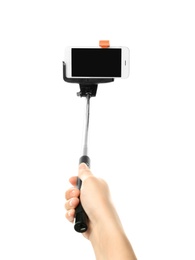 Photo of Woman holding selfie stick with mobile phone on white background