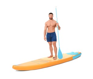 Photo of Handsome man with paddle on orange SUP board against white background