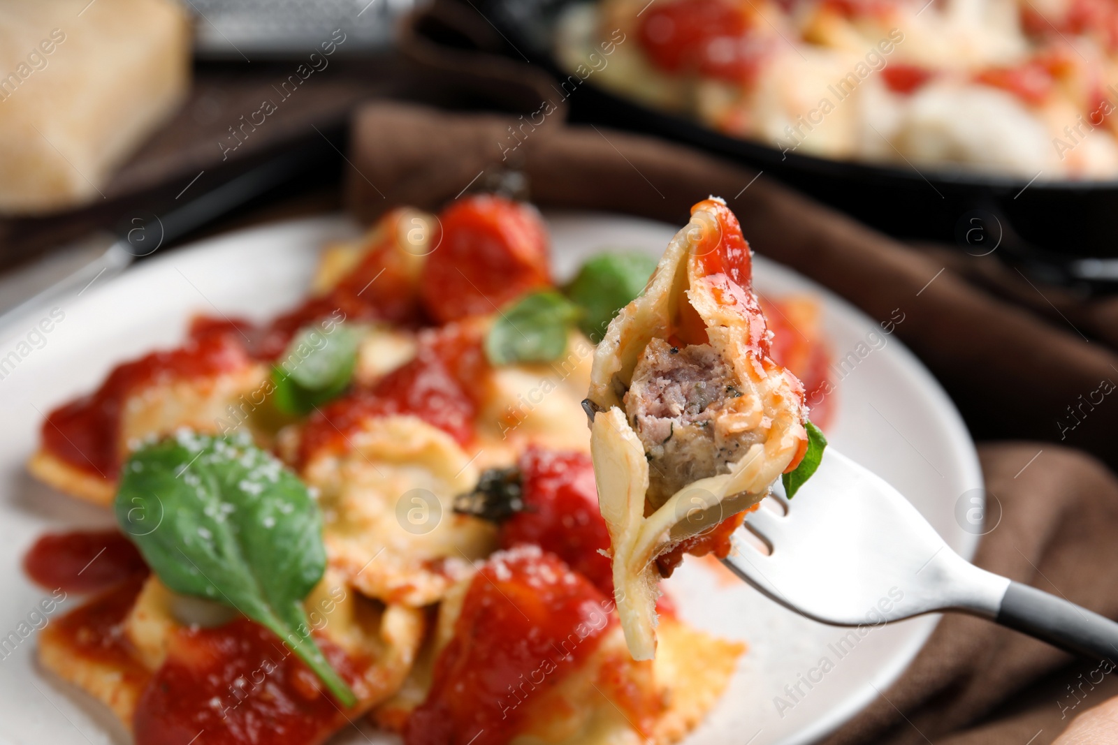 Photo of Eating traditional ravioli with tasty filling, closeup