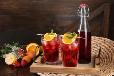 Delicious refreshing sangria, fresh fruits and berries on wooden table