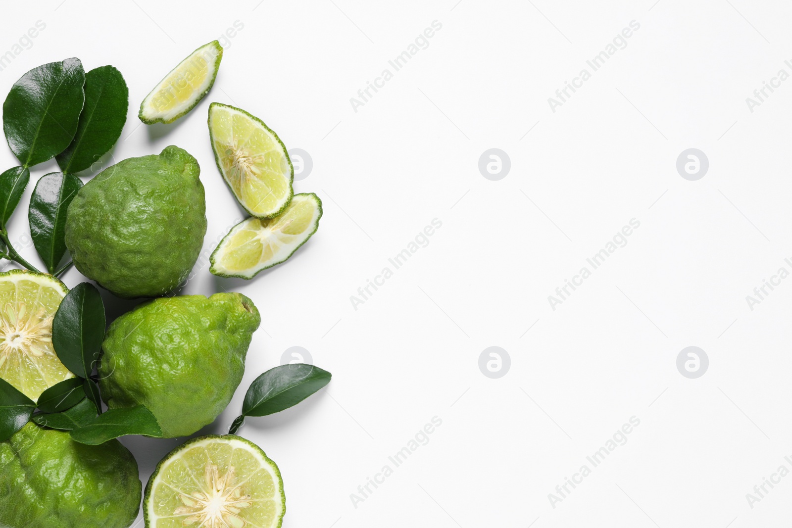 Photo of Flat lay composition with ripe bergamot fruits on white background. Space for text