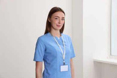 Photo of Smiling doctor with blank badge in hospital