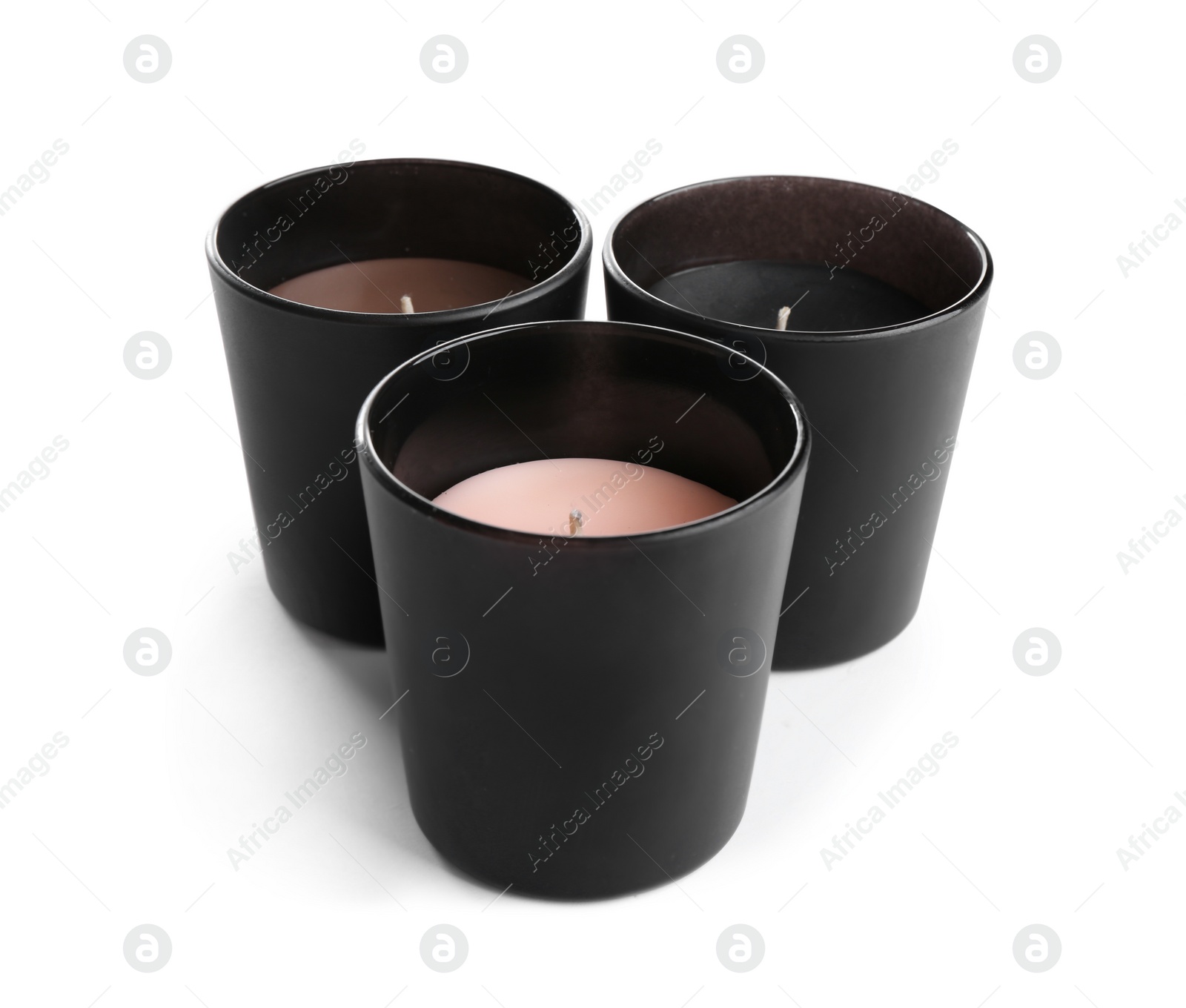 Photo of Aromatic candles in black holders isolated on white