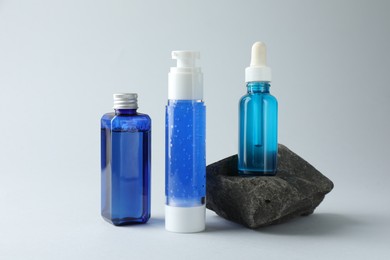 Set of cosmetic products on light grey background