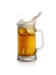 Beer splashing out of glass on white background