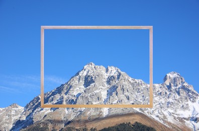 Wooden frame and beautiful mountains covered with snow