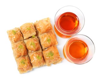 Photo of Delicious baklava with pistachios and hot tea on white background, top view