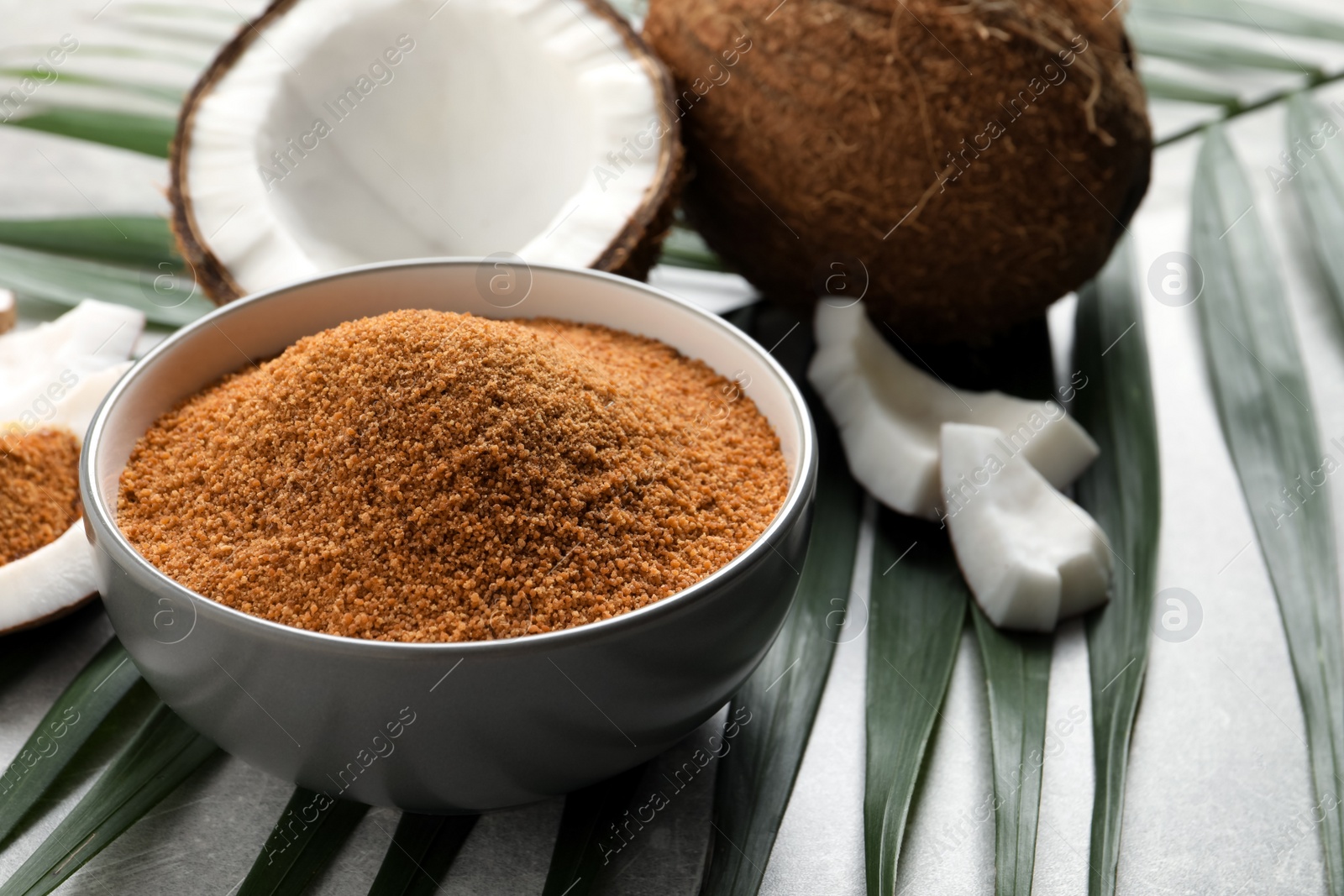 Photo of Composition with natural coconut sugar on grey table