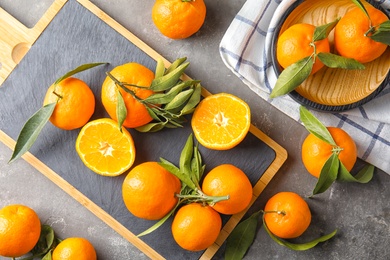Photo of Flat lay composition with ripe tangerines on grey background