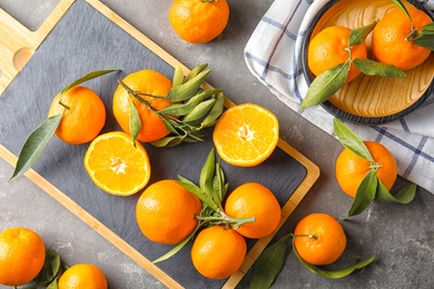 Flat lay composition with ripe tangerines on grey background