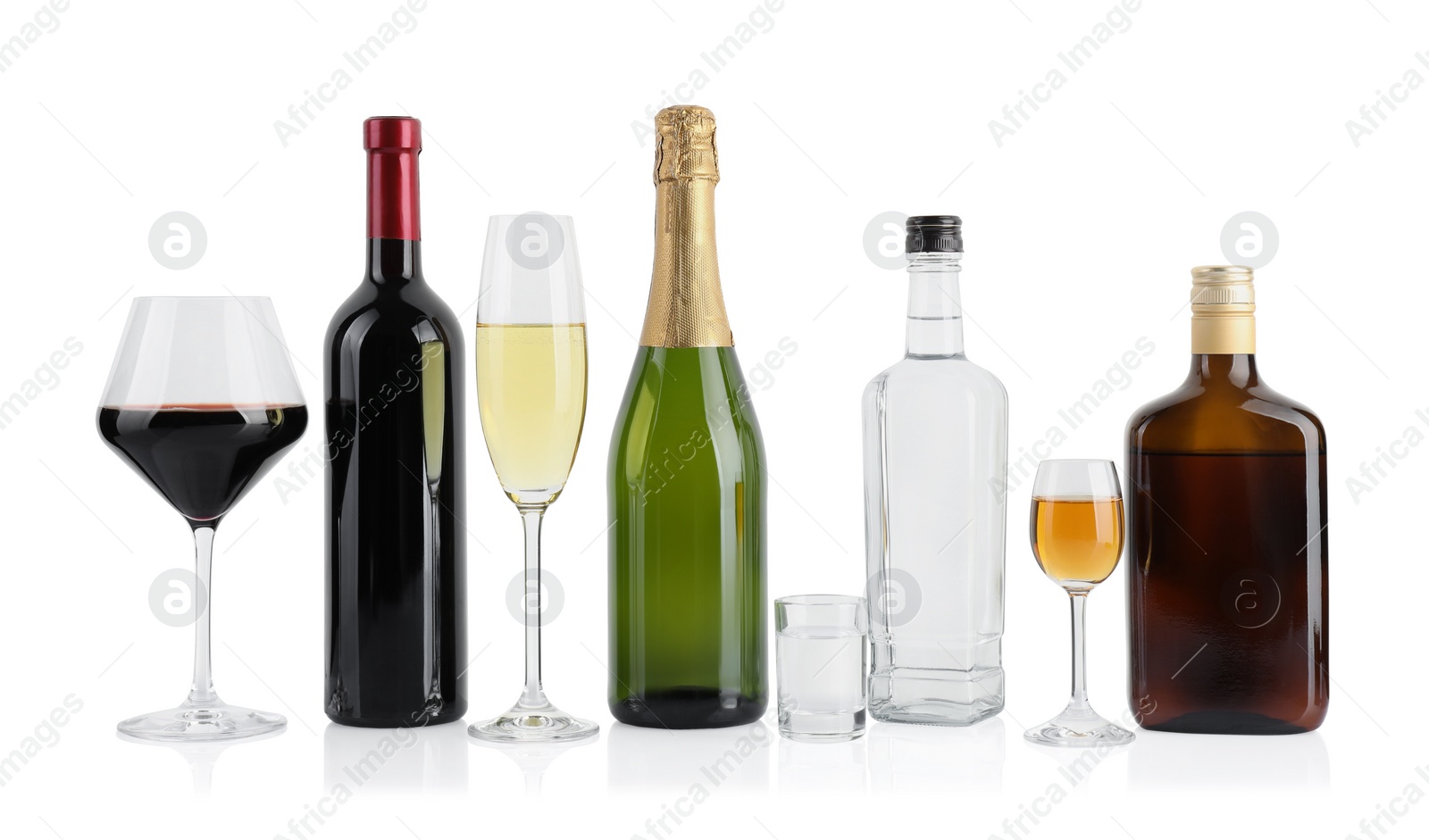 Photo of Bottles and glasses with different alcoholic drinks isolated on white