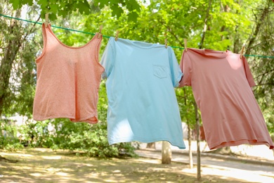 Photo of Laundry line with clothes outdoors on sunny day