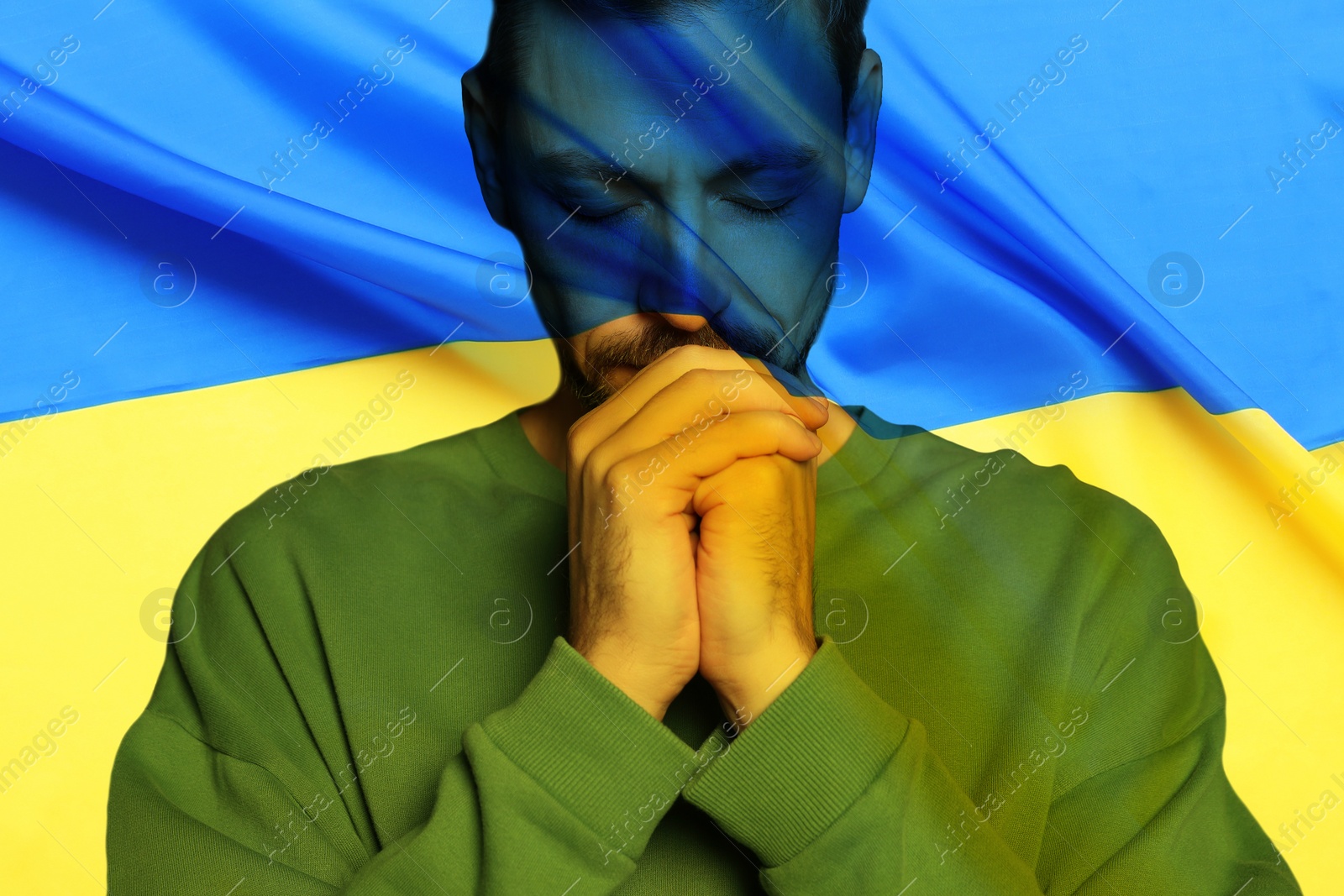 Image of Double exposure of national flag and man praying. Stop war in Ukraine